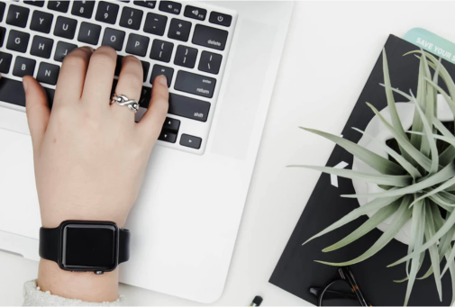 hand typing on laptop keyboard