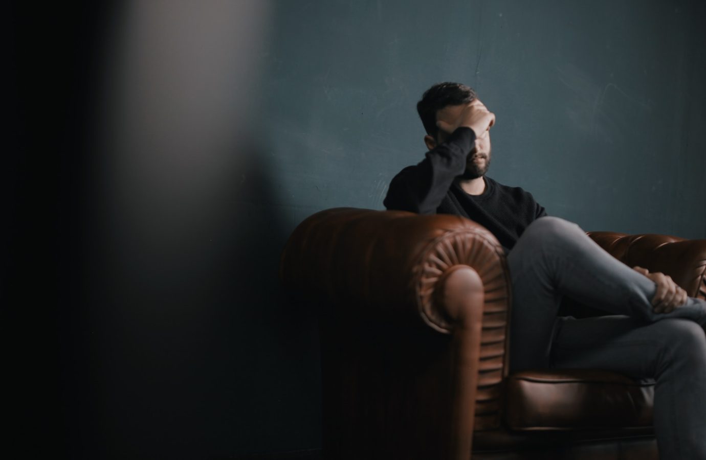 Emotional Man sitting on Couch