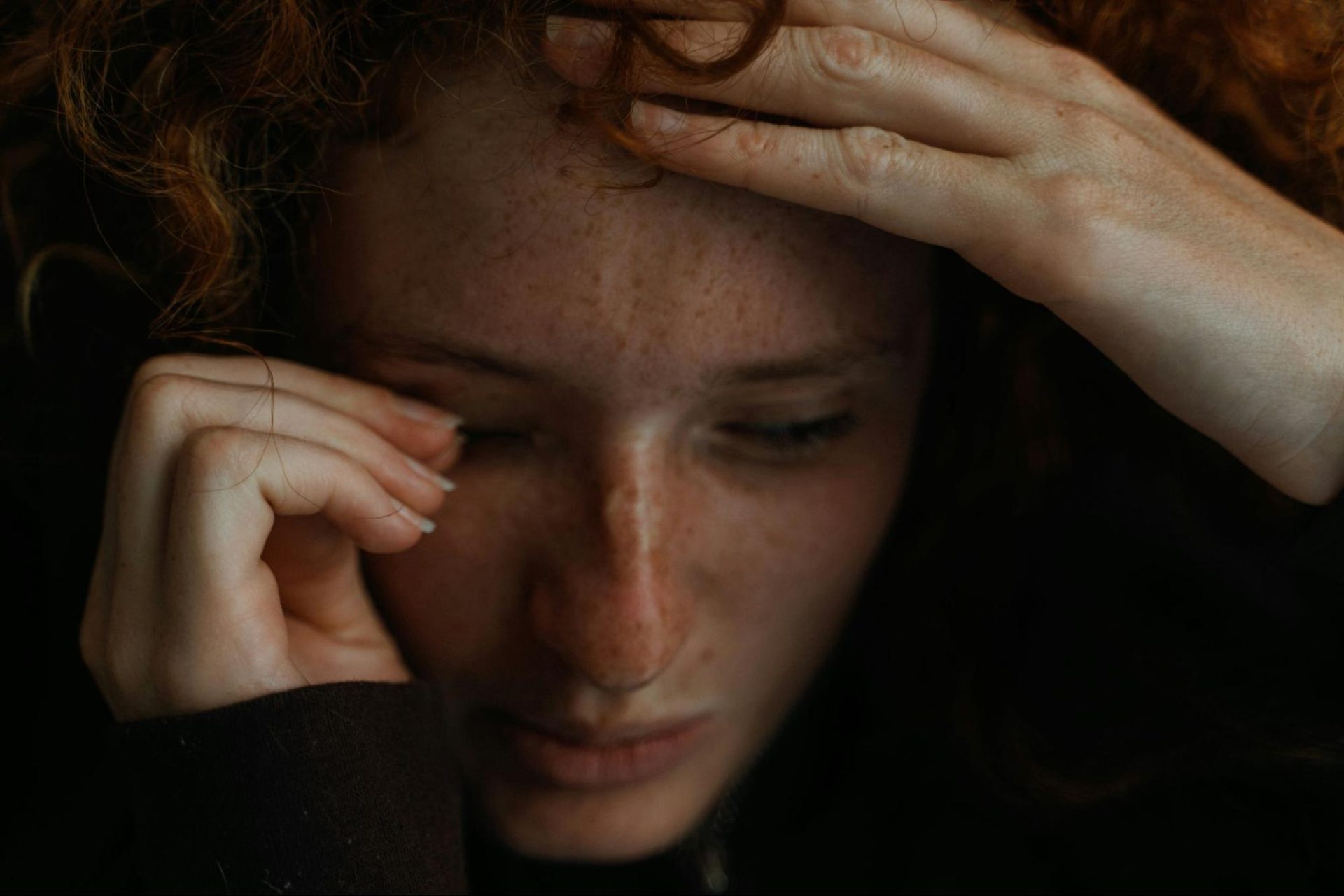 Woman looking distraught, reliving trauma.