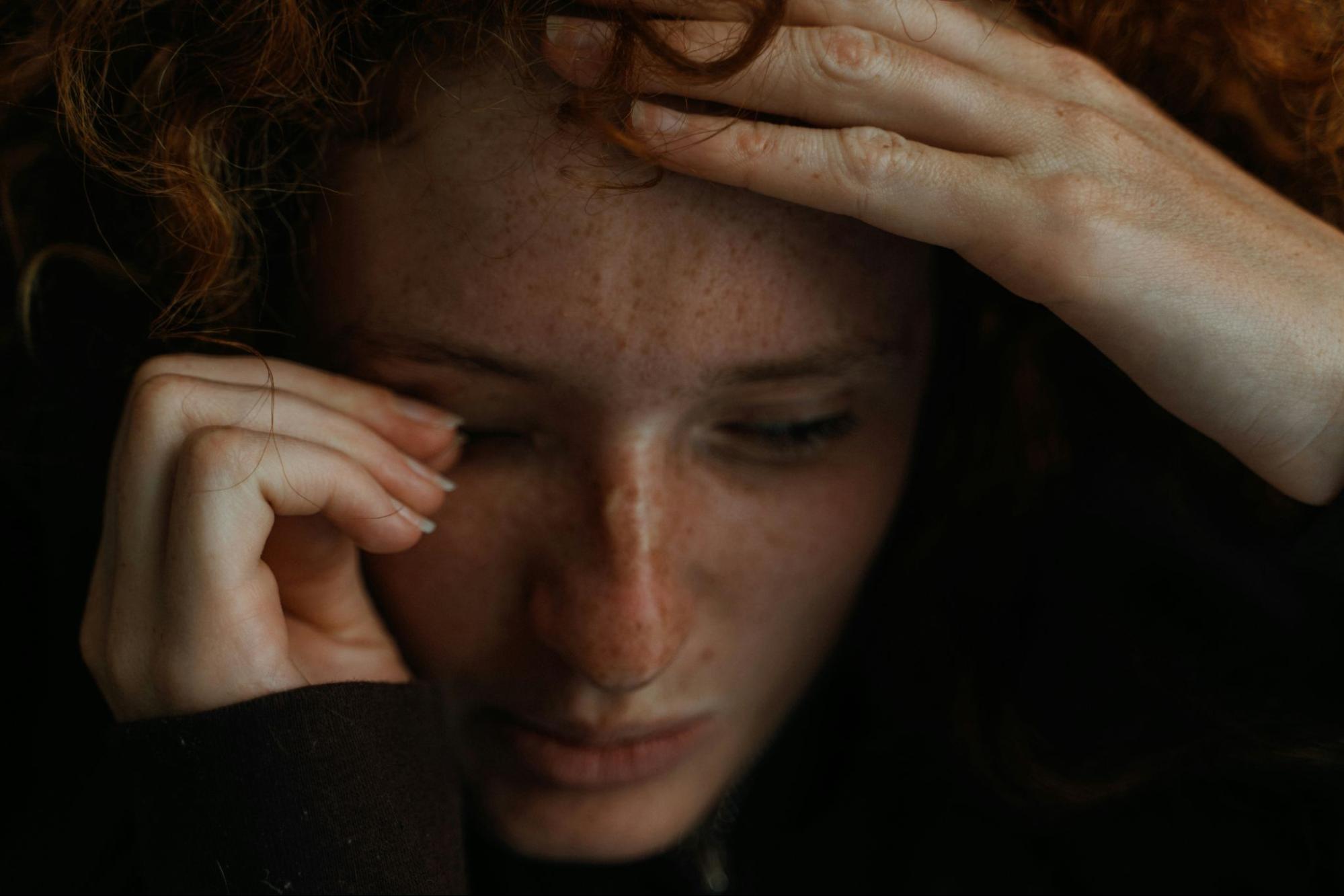 Woman looking distraught, reliving trauma.