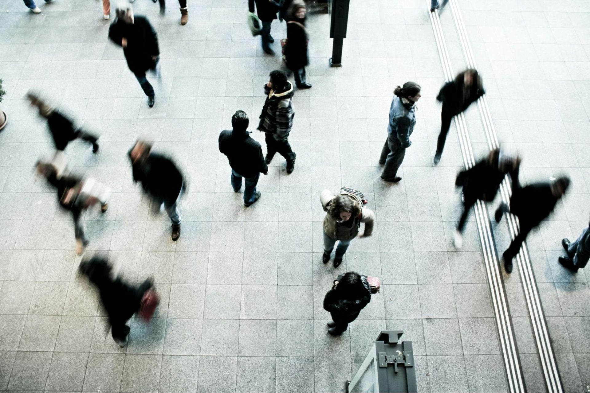 People on a busy urban sidewalk all going different directions.