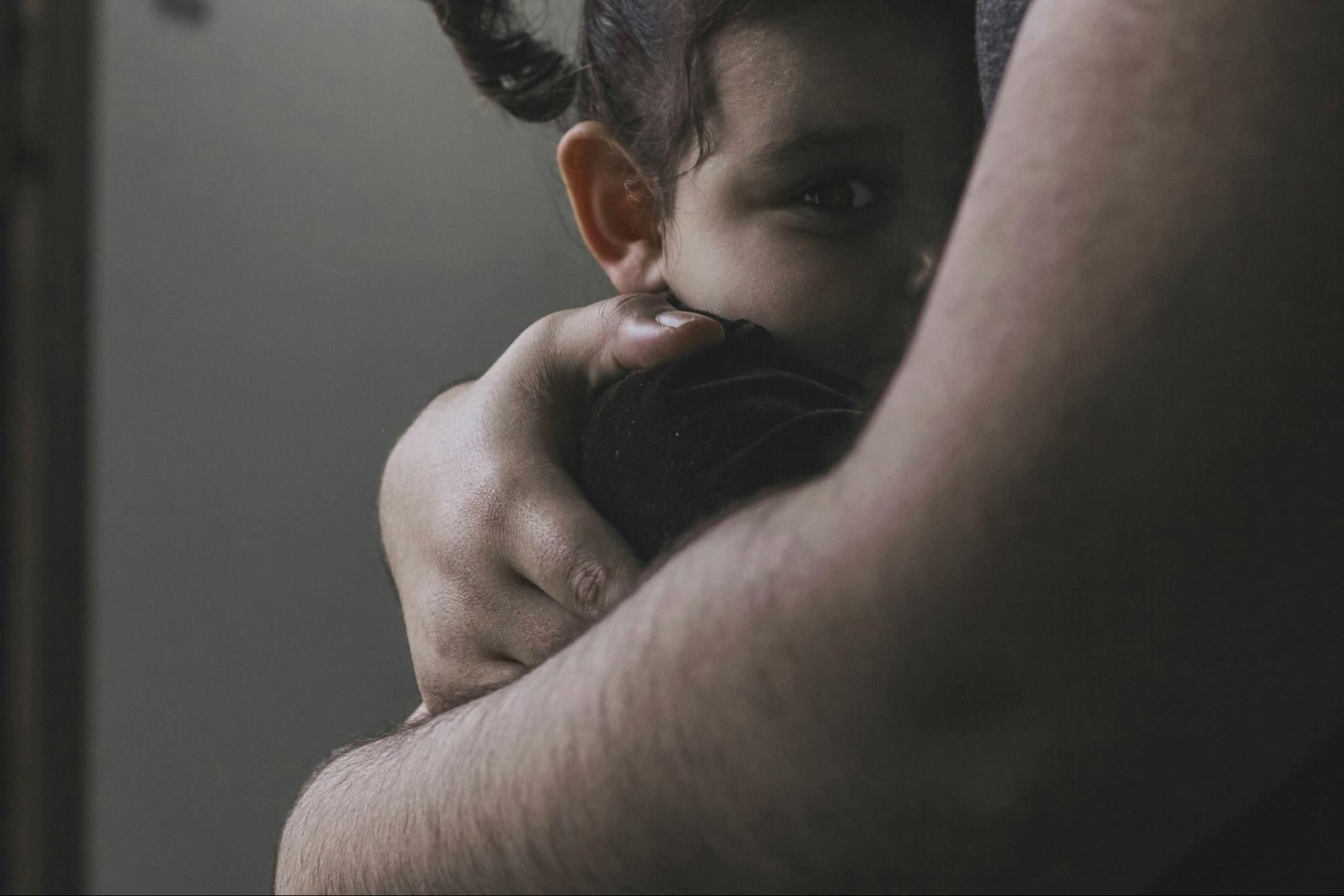 Mother cradling baby. 