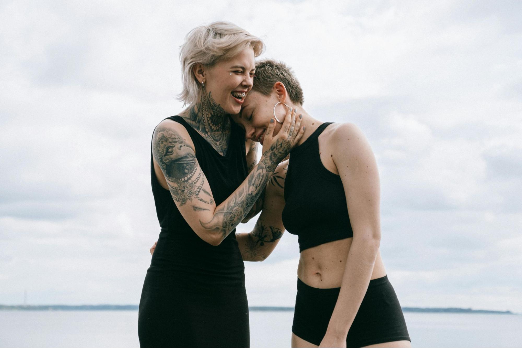 Lesbian couple hugging and smiling. 