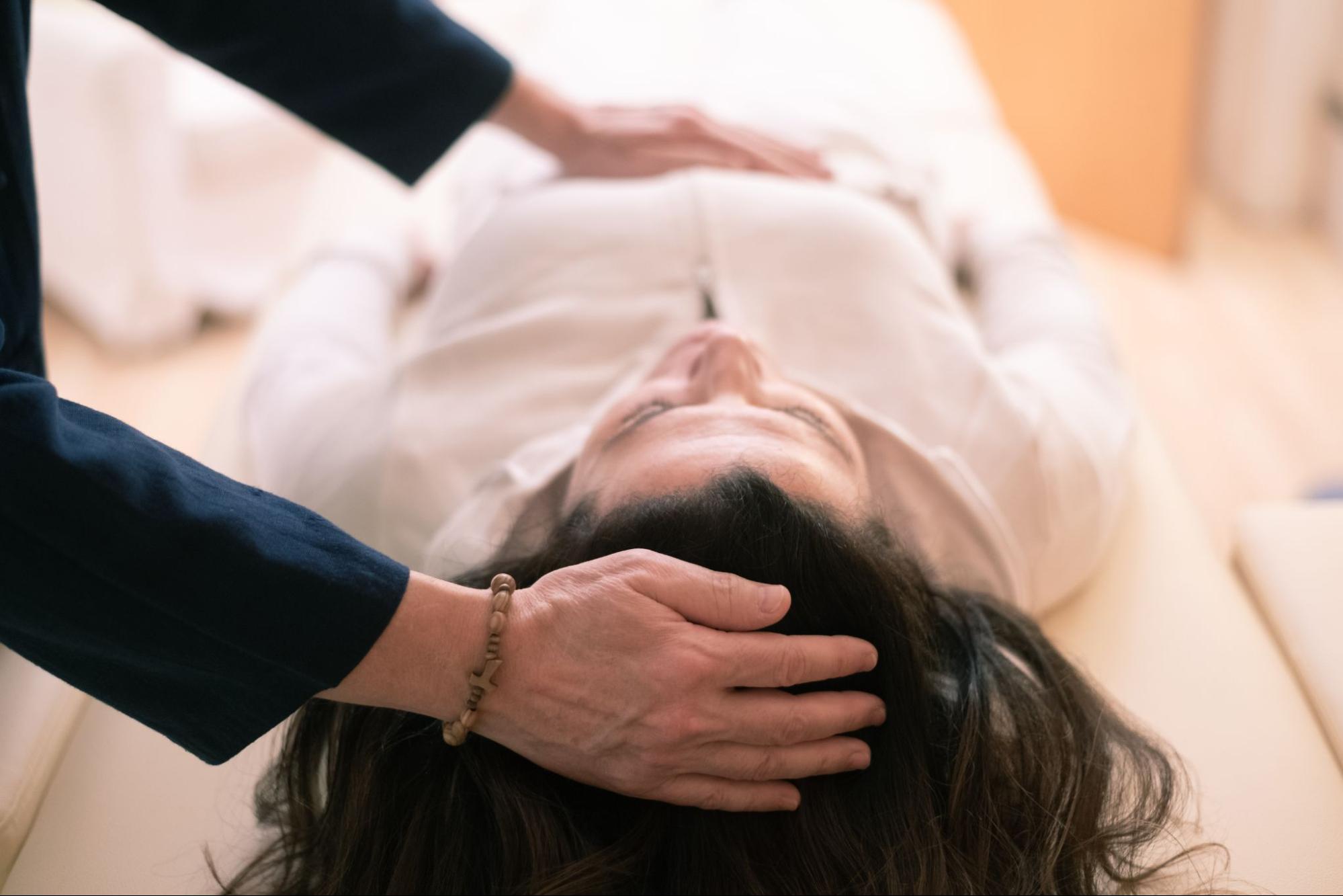 Woman receiving a somatic therapy treatment. 