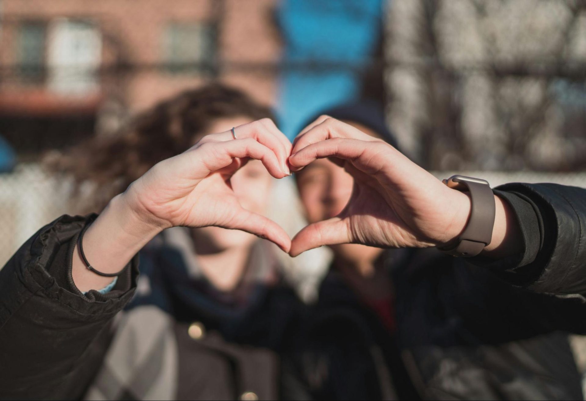 Couple forming a heart shape with their hands together.