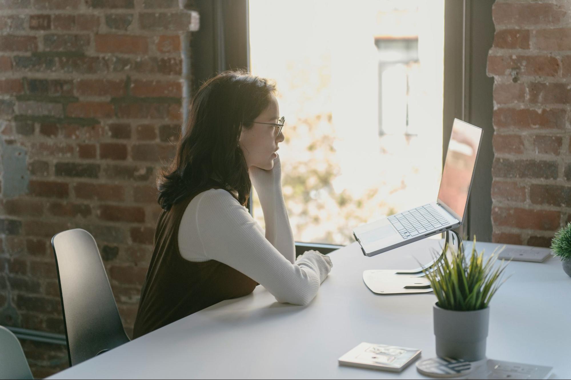 Young therapist in an office doing an online counselling session on her laptop. 
