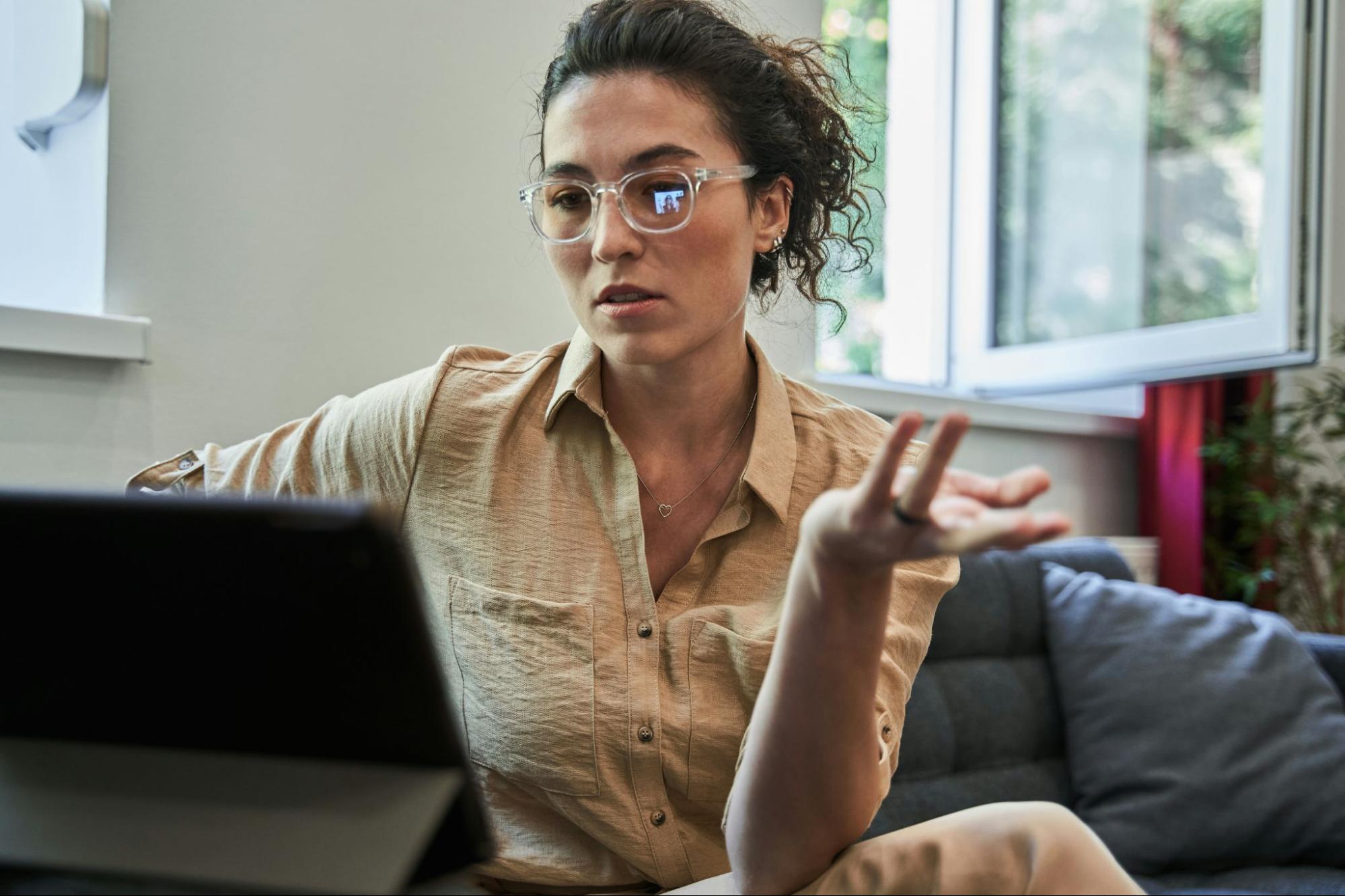 Online therapist working with client in a videochat on her tablet. 